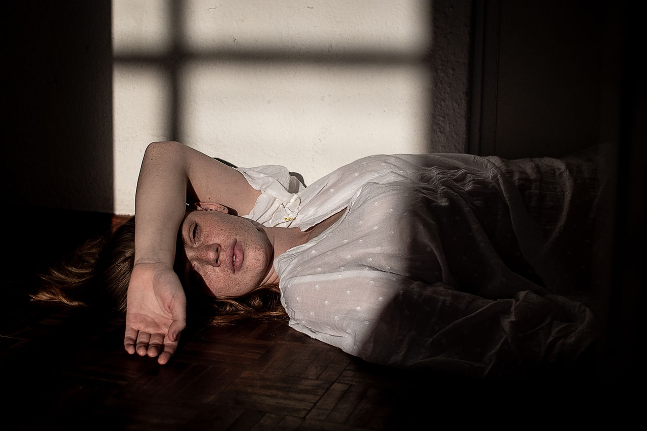 Portrait of woman lying down at home