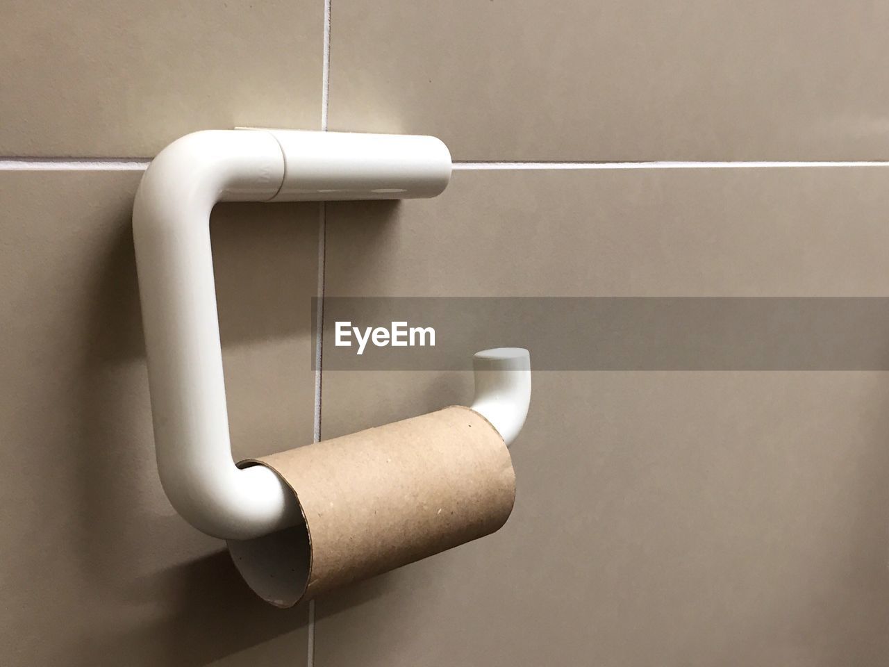 Close-up of empty paper roll in bathroom