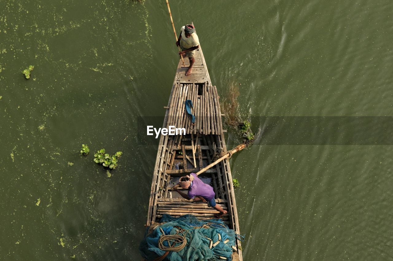 High angle view of man riding a boat 