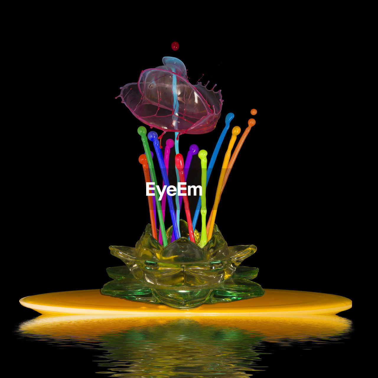 Close-up of multi colored water splashing against black background
