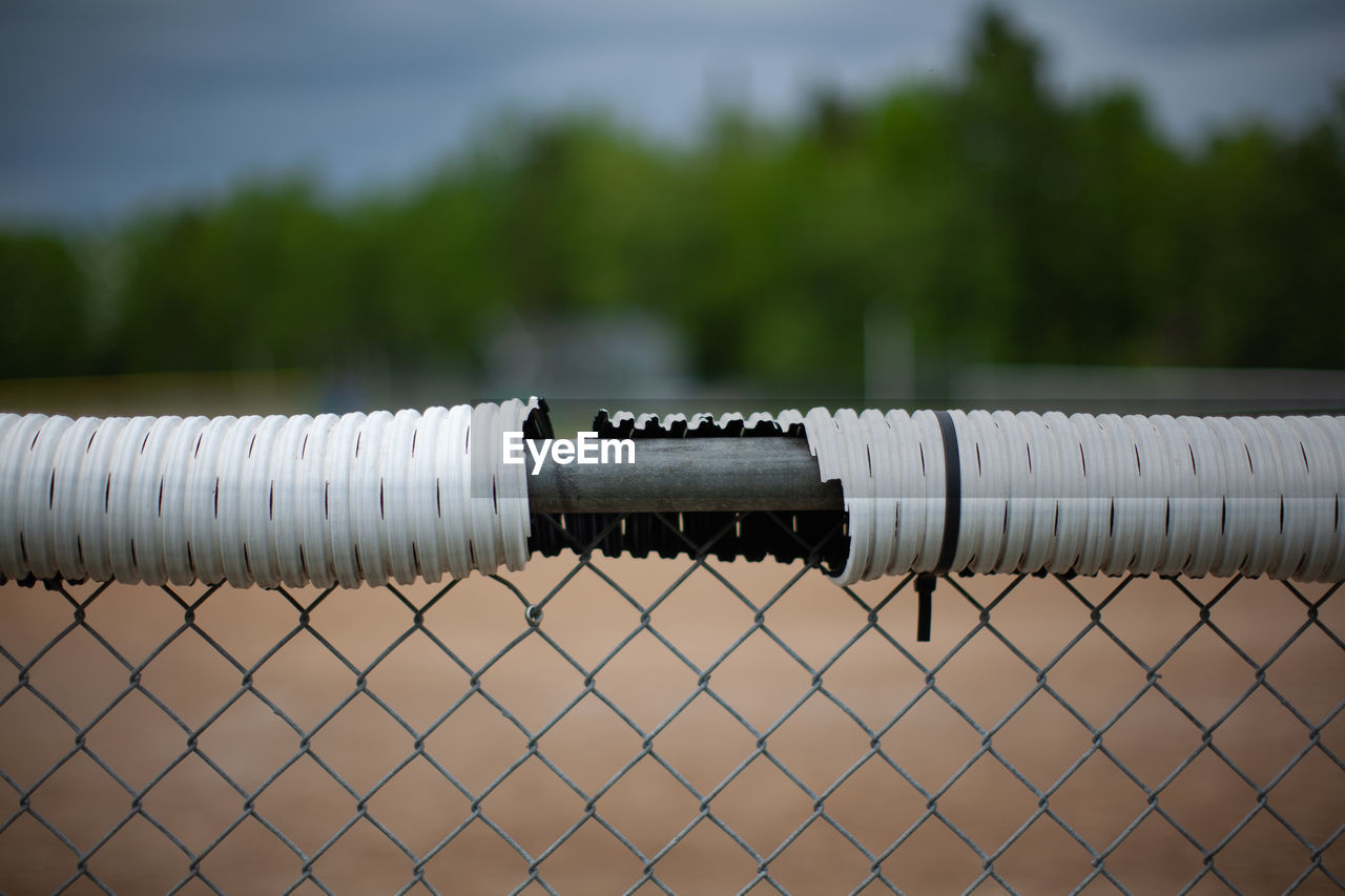 Close-up of metal pipes on land