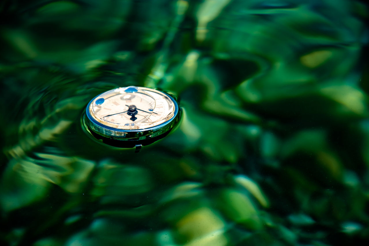 green, time, clock, close-up, macro photography, no people, instrument of time, light, leaf, water, watch, nature, reflection, clock face, darkness, selective focus