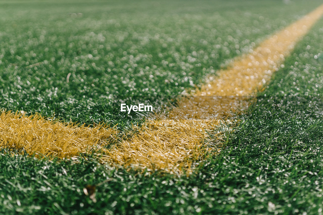 Close-up of yellow yard line on soccer field
