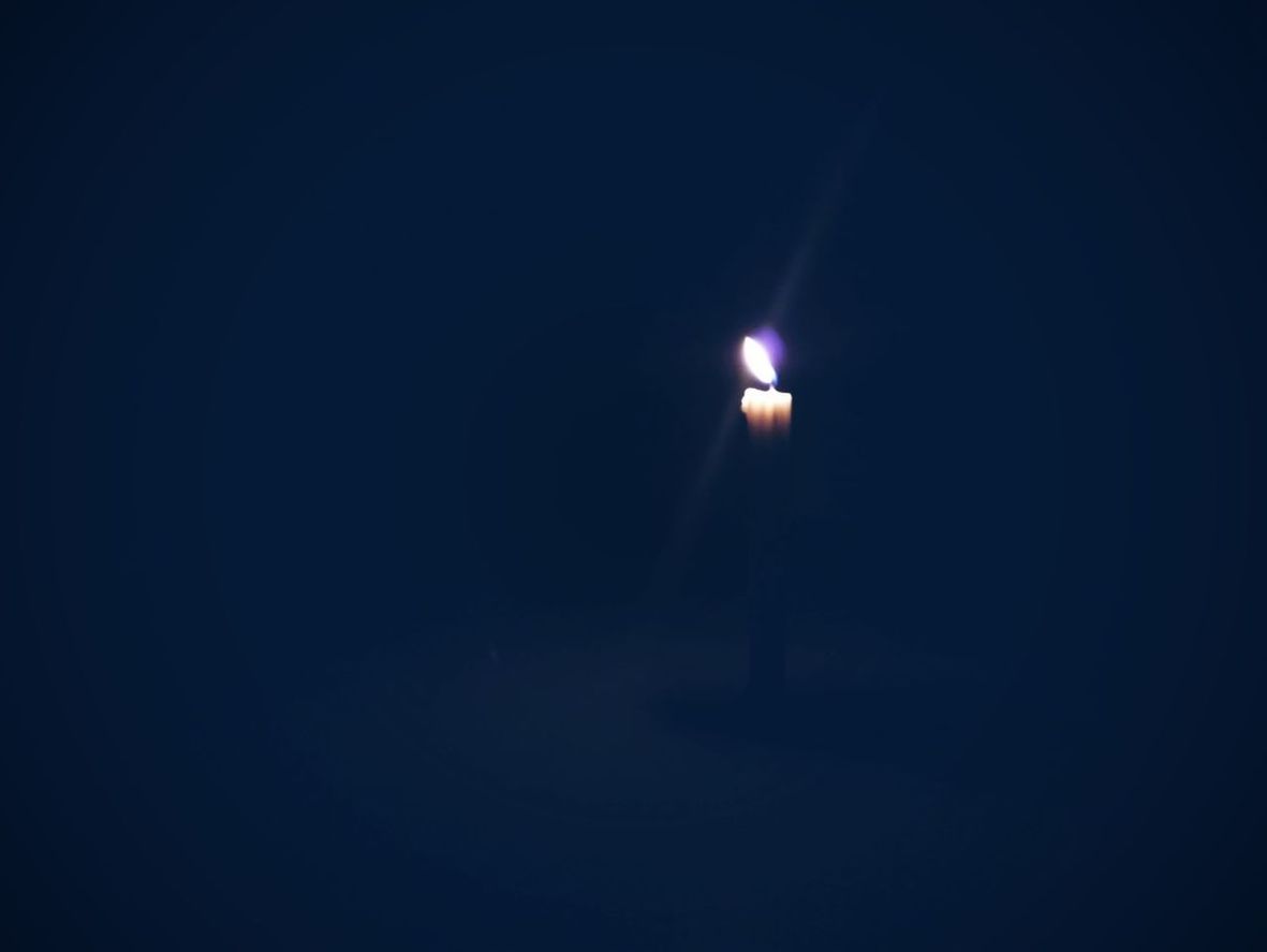 VIEW OF ILLUMINATED LAMP IN DARK ROOM