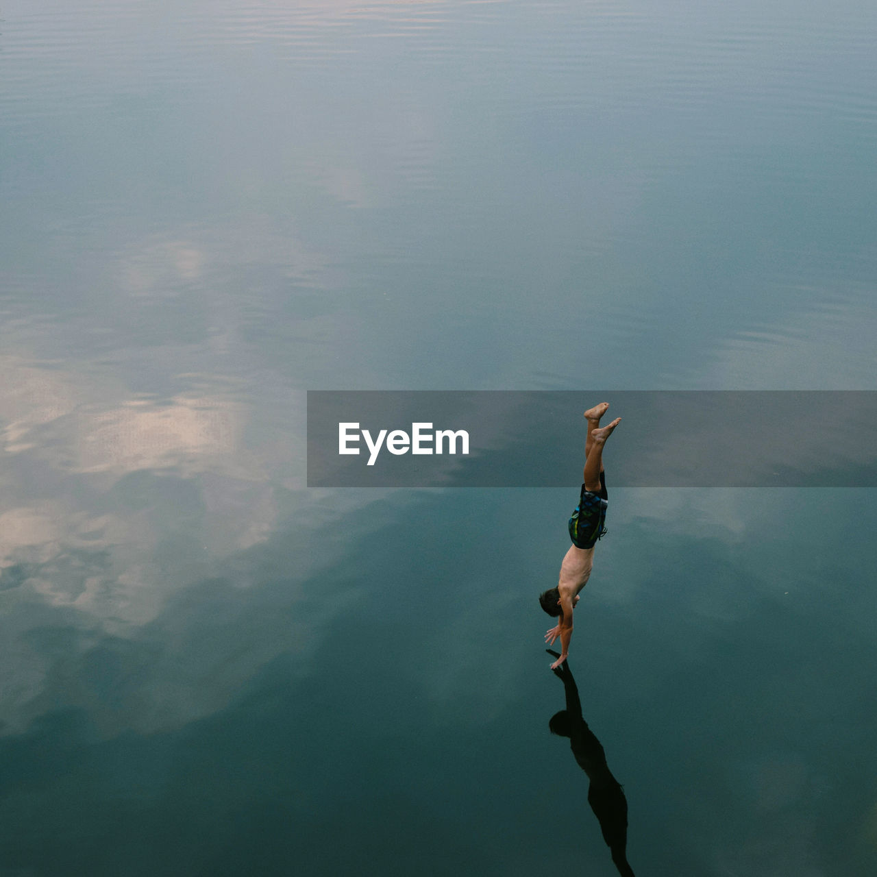 High angle view of man diving into calm lake