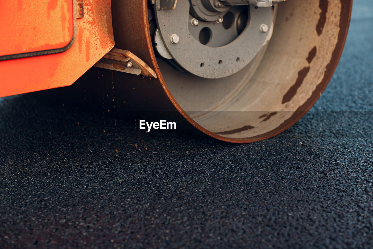 Close-up of road roller on asphalt