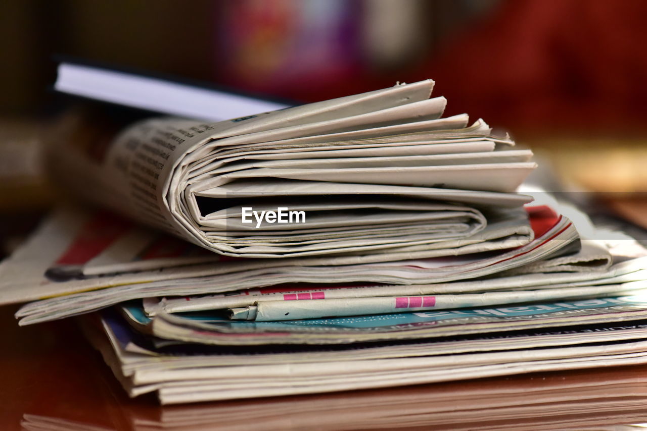 Close-up of newspapers on table