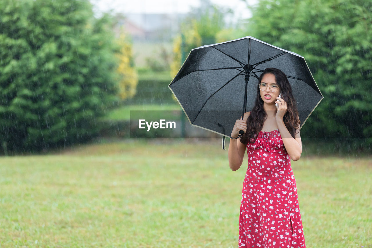 portrait of woman holding umbrella