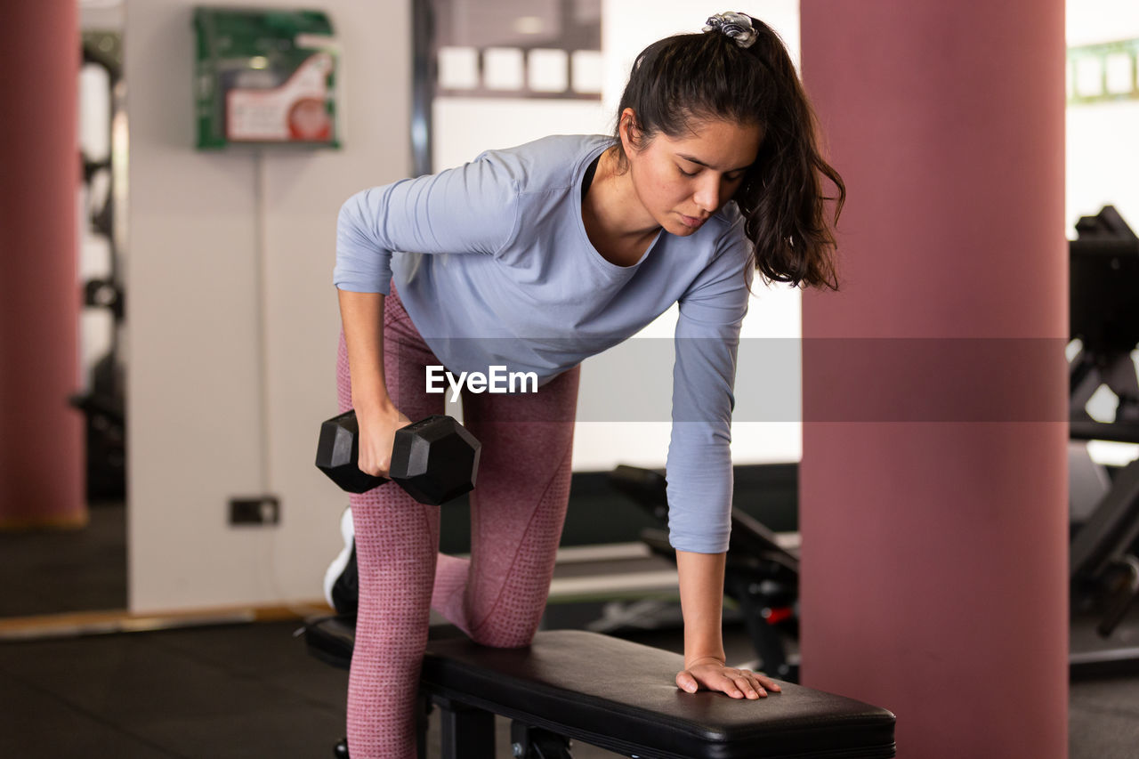 side view of man exercising in gym