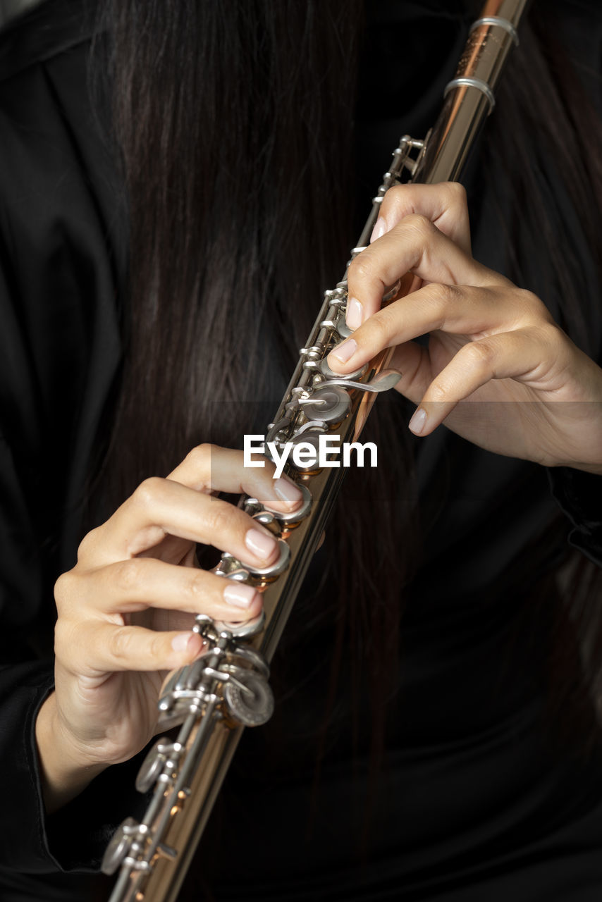 Golden flute played by a young woman