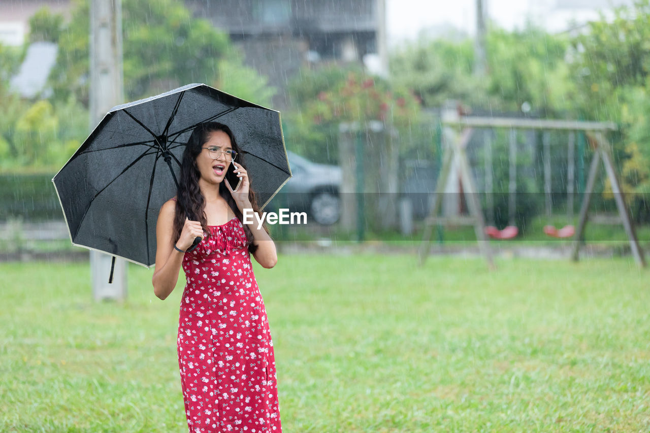 portrait of woman holding umbrella