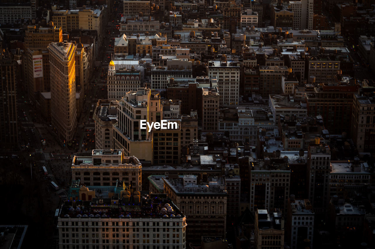 Illuminated flatiron building from the top of the empire state in new york