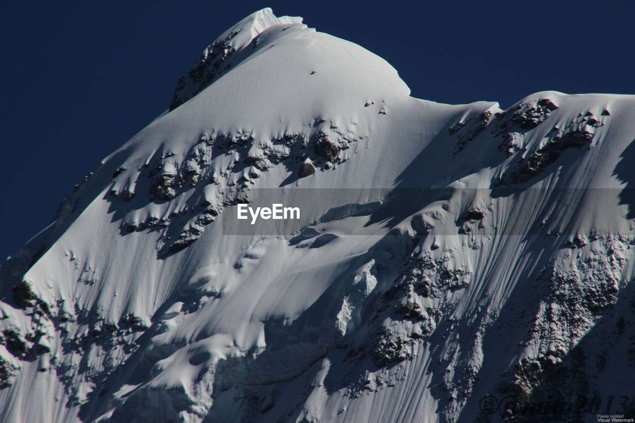 Scenic view of snowcapped mountain against clear sky