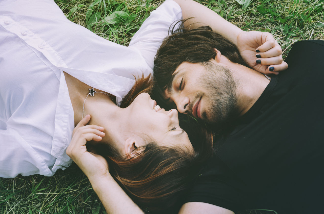 Young couple relaxing on field
