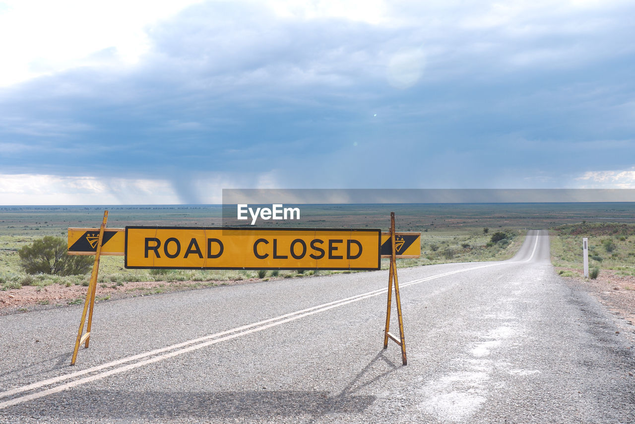 Road closed sign along countryside landscape