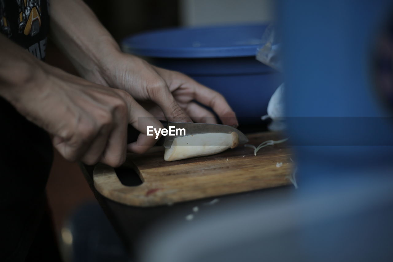 Cropped image of person cutting food
