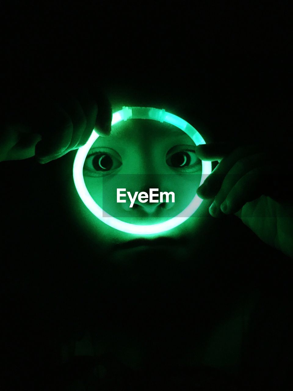 Close-up of boy holding illuminated glow ring