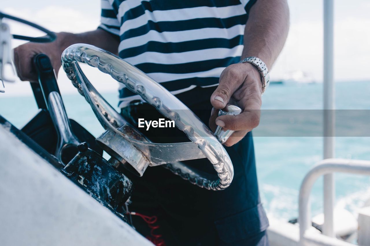 Midsection of man riding boat