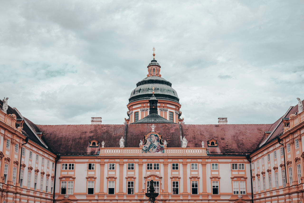 Low angle view of church against cloudy sky