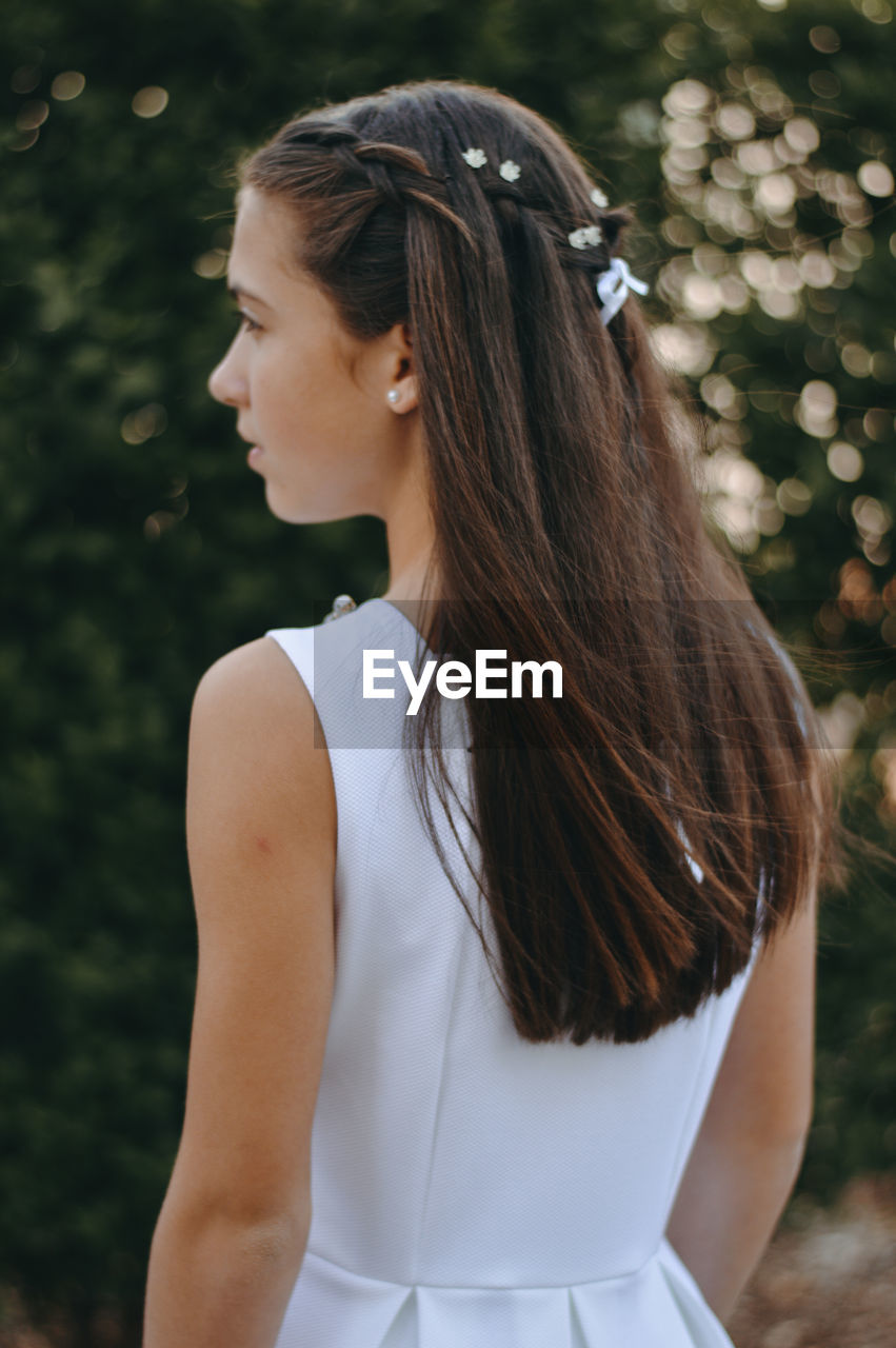 Teenage girl with long hair looking away