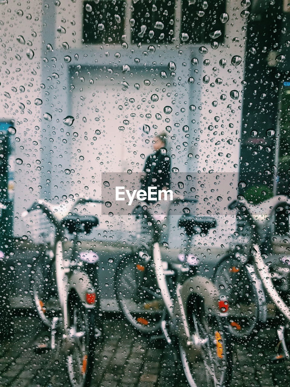 Water on glass with bicycle in background