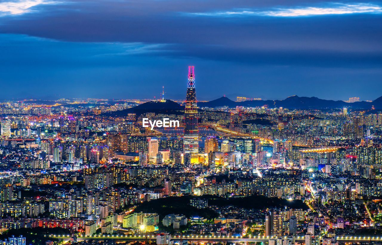 High angle view of city lit up at night