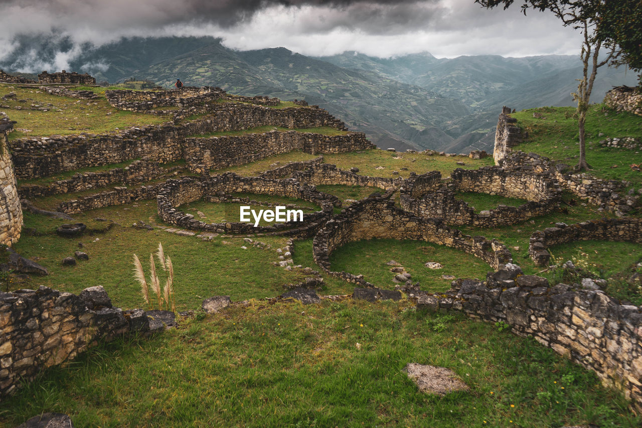 Chachapoyas ruins in peru. view of green landscape against cloudy sky.