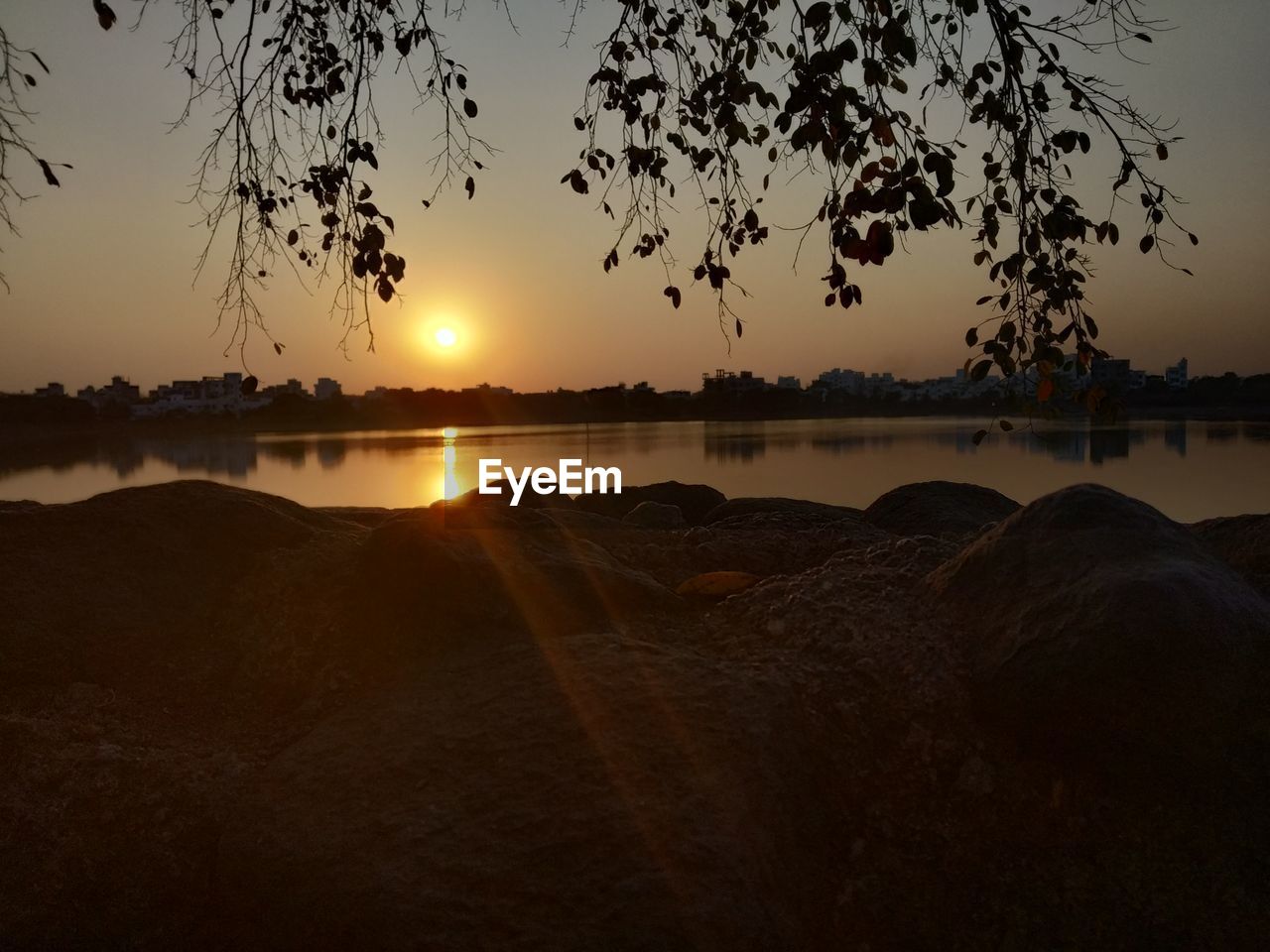 SCENIC VIEW OF LAKE AGAINST ORANGE SKY DURING SUNSET