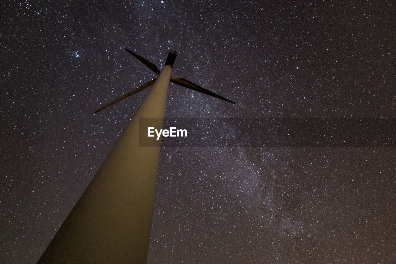 LOW ANGLE VIEW OF WIND TURBINE AGAINST SKY AT NIGHT