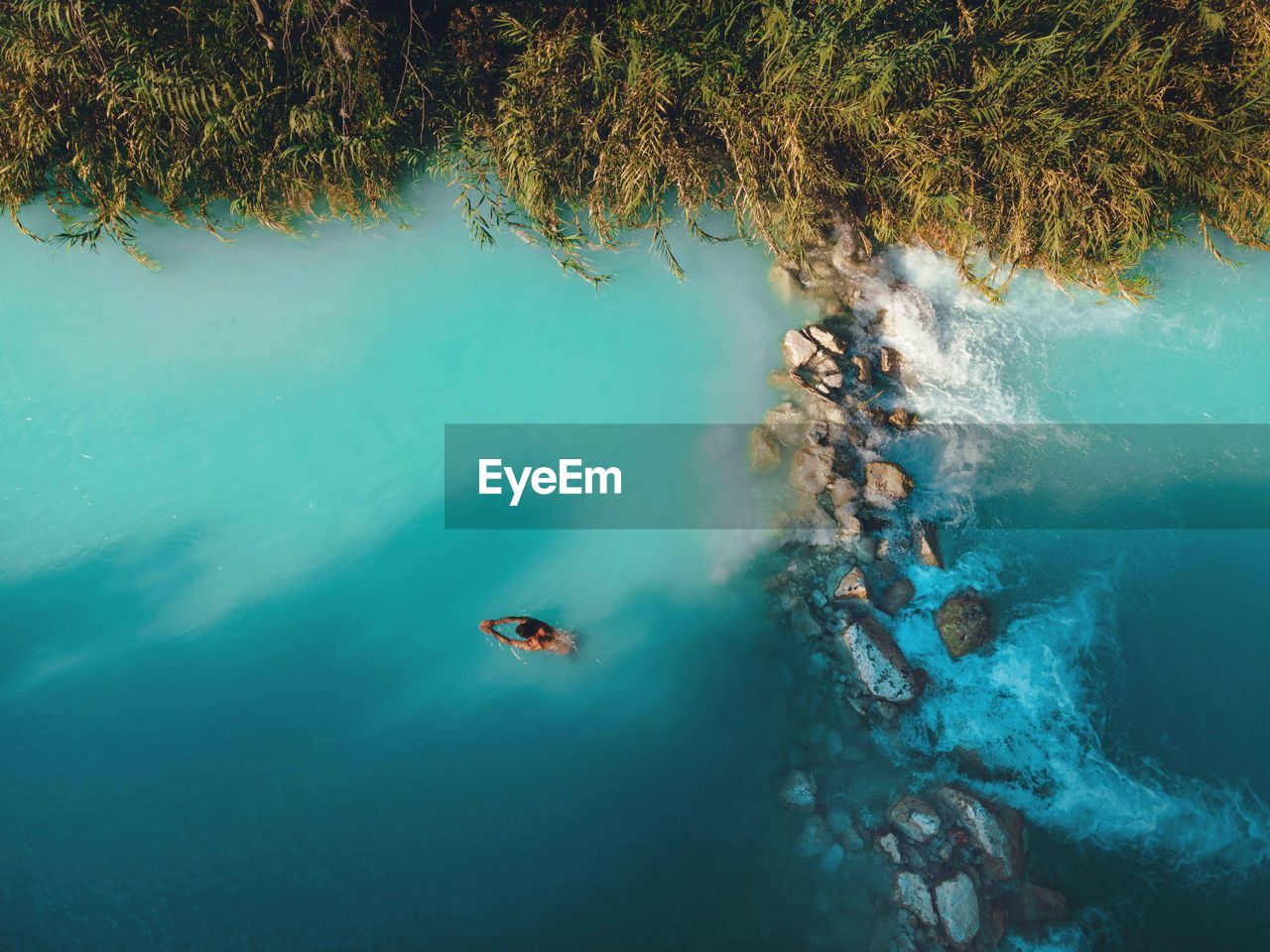 high angle view of man swimming in lake