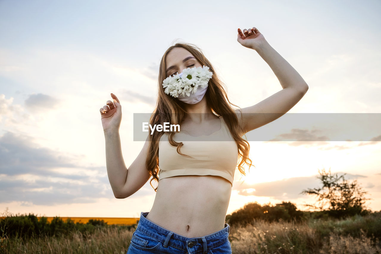 Statement masks, blinged out diy flower face mask design. girl in face mask decorated with flowers 