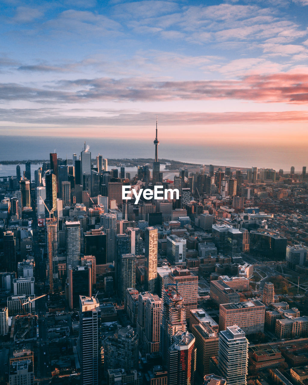 Aerial view of buildings in city at sunset