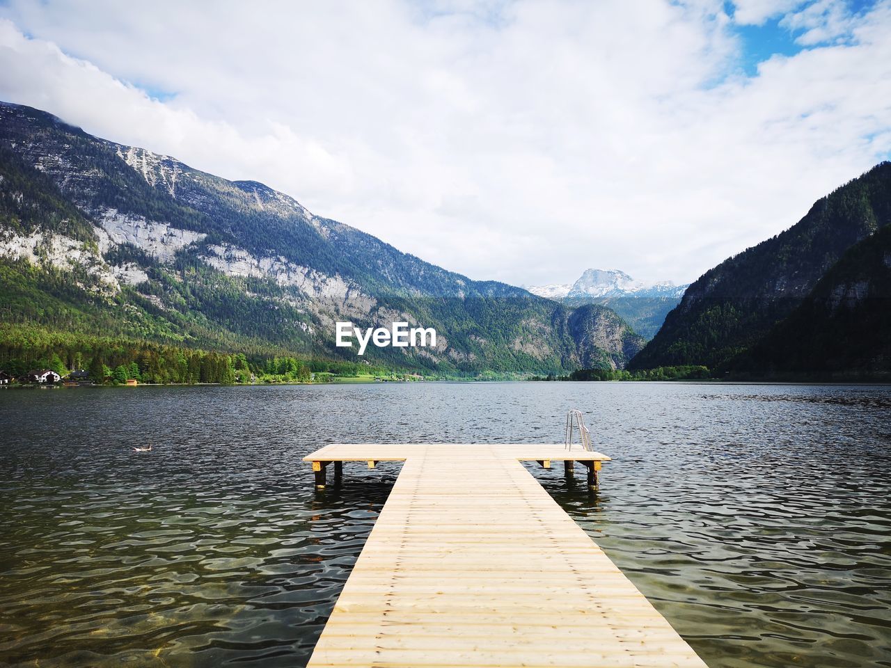 Pier over lake against mountains