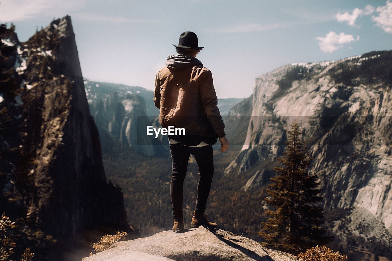 Rear view of man standing on mountain