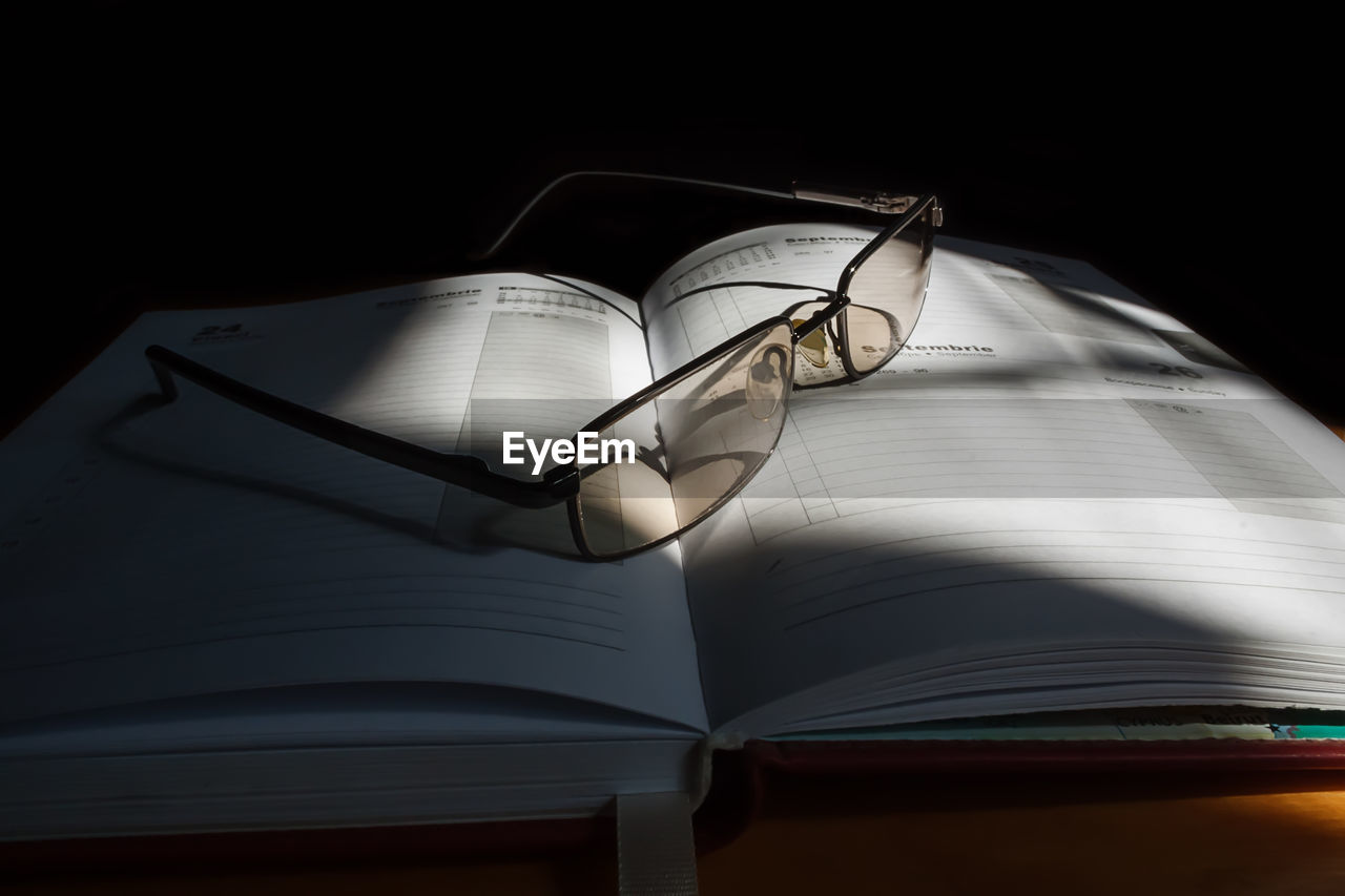 Close-up of eyeglasses on open book 