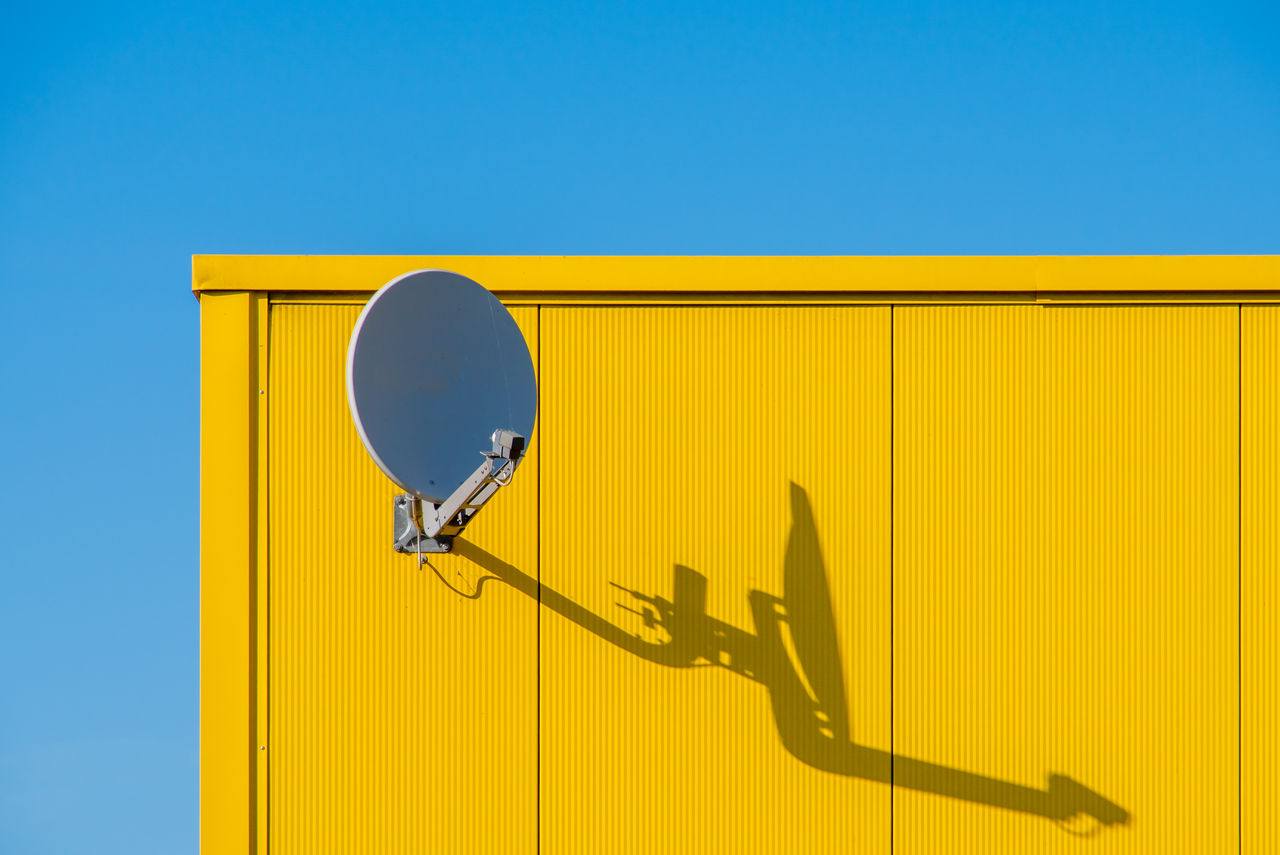 Low angle view of satellite dish against blue sky