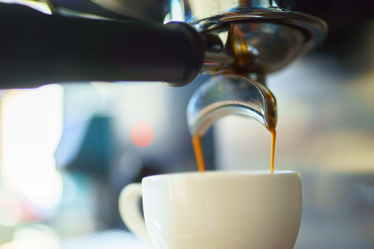 close-up of coffee pouring in cup