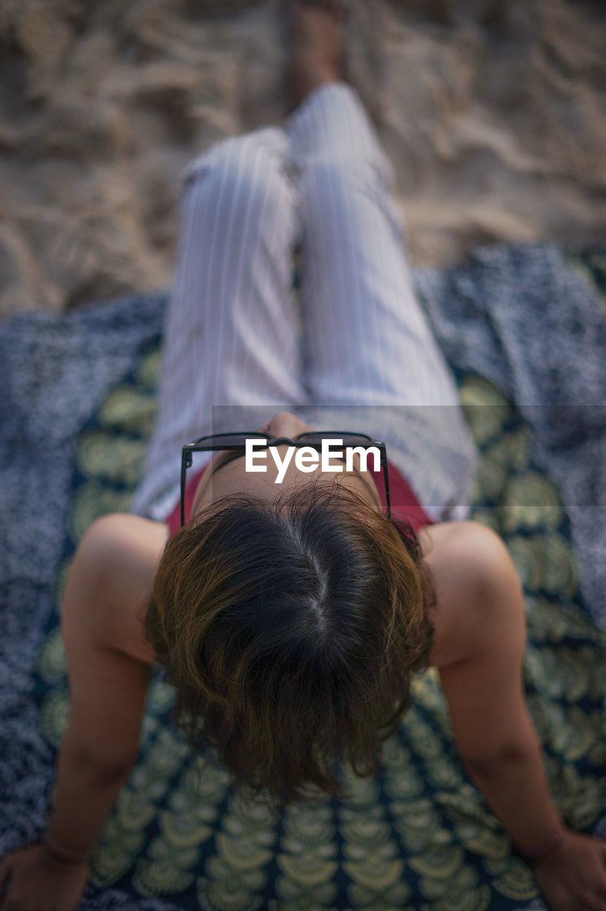 High angle view of woman sitting on beach