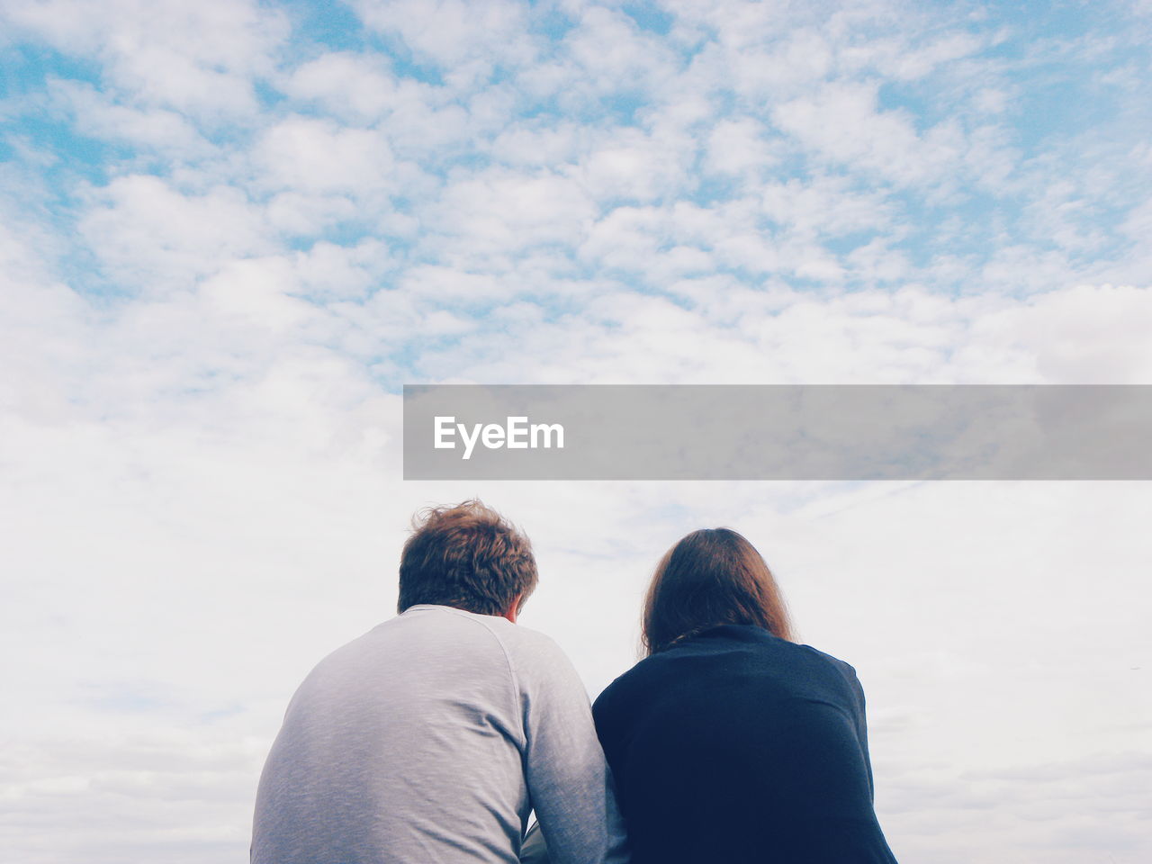 Rear view of couple against sky