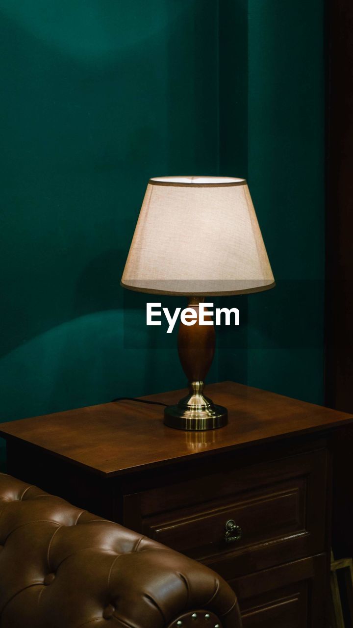 Electric lamp on table at home