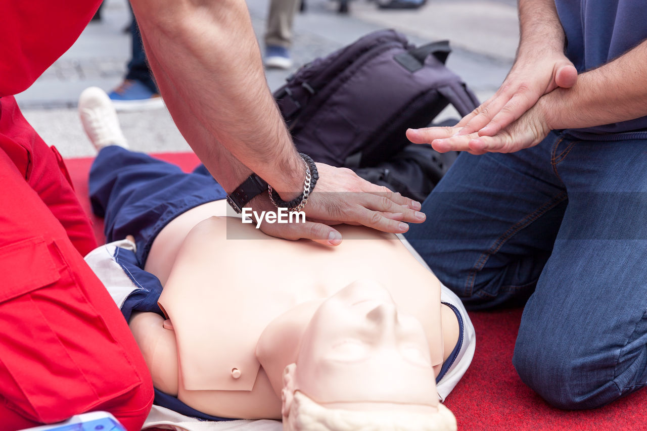 Instructor teaching cpr on dummy