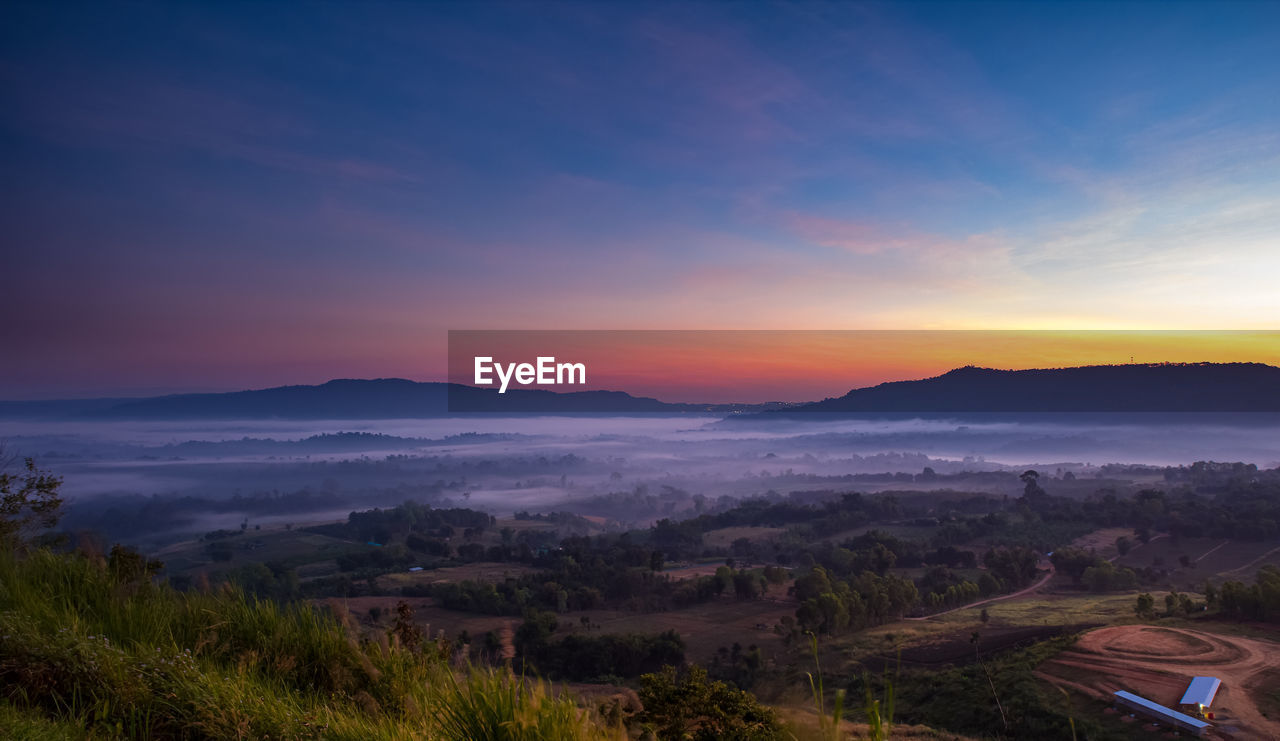 SCENIC VIEW OF LANDSCAPE AGAINST SUNSET SKY