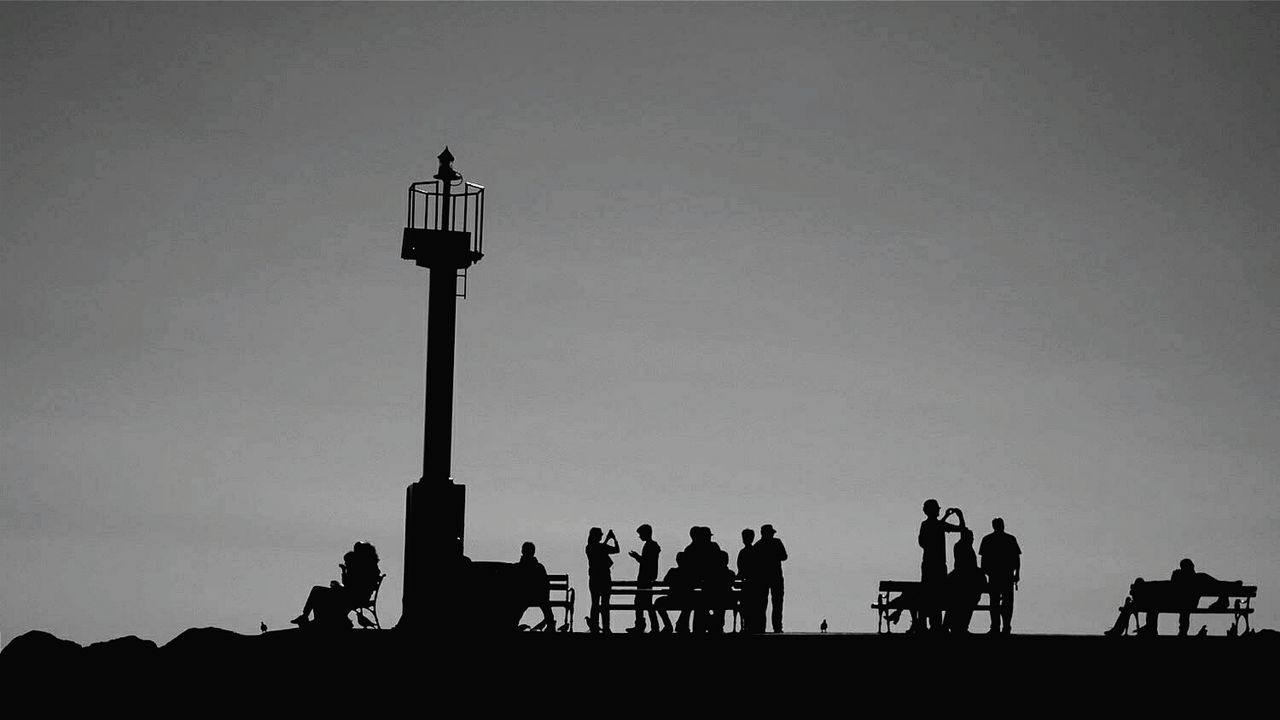 SILHOUETTE PEOPLE ON STAGE AGAINST SKY