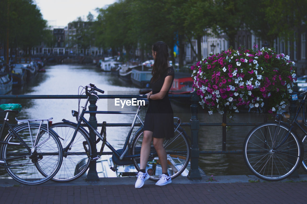 Bicycle Cycling Transportation Mode Of Transport Water Full Length Lake Outdoors Adult Day People Land Vehicle Social Issues One Person City Standing Lifestyles One Woman Only Adults Only Women Amsterdam GetbetterwithAlex Brandon Woelfel Interrail Landscape The Week On EyeEm EyeEmNewHere Been There. Done That. Lost In The Landscape Connected By Travel Perspectives On Nature Rethink Things Postcode Postcards Second Acts