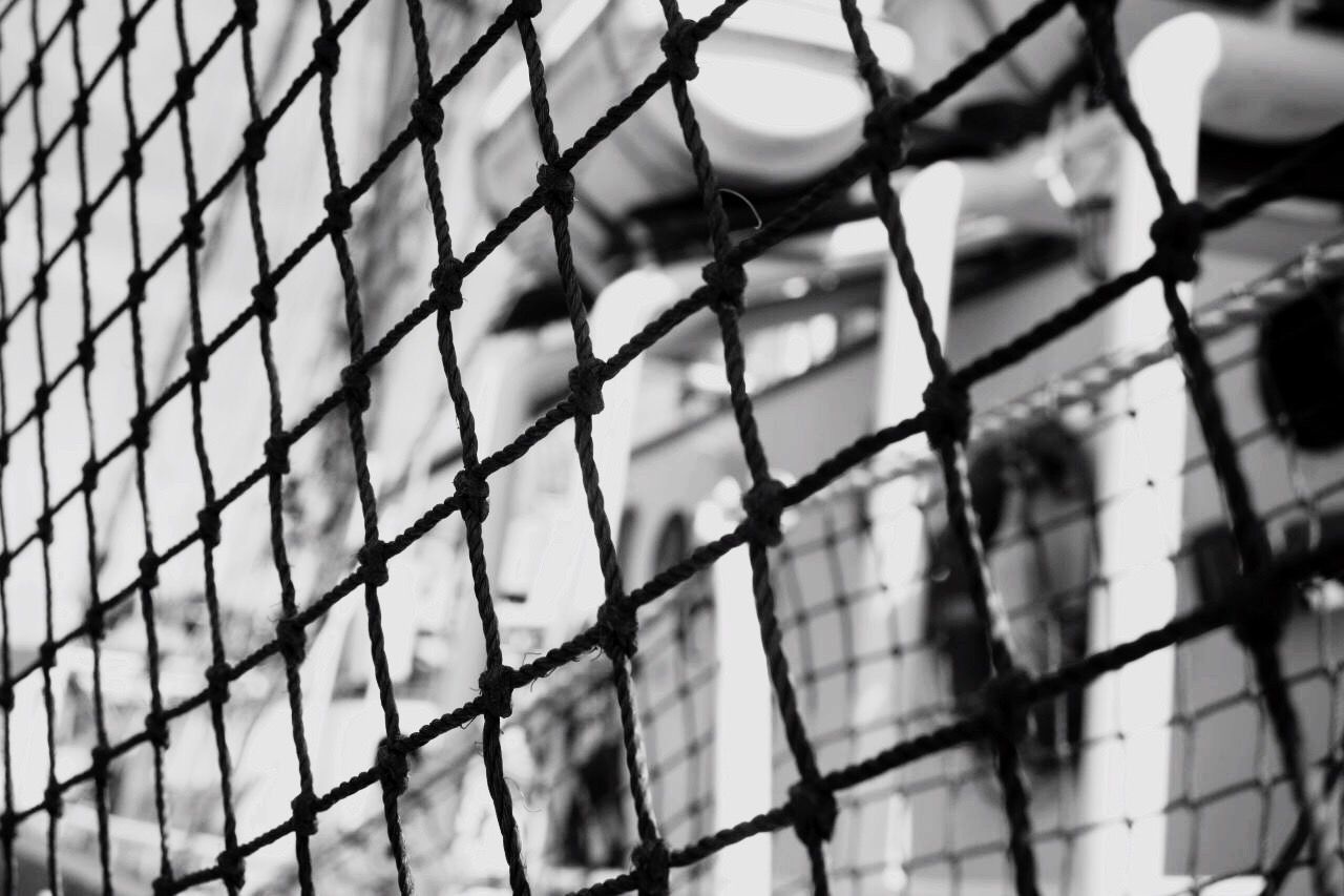 LOW ANGLE VIEW OF FENCE AGAINST SKY SEEN THROUGH CHAINLINK