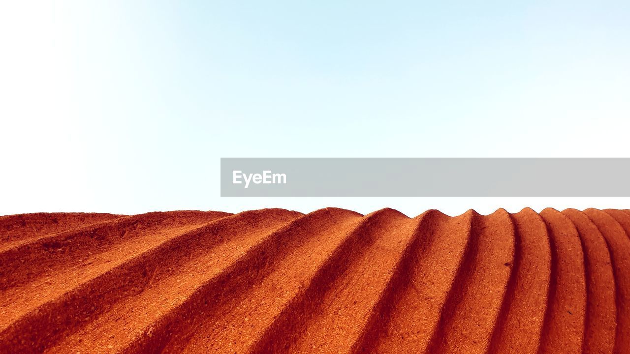 CLOSE-UP OF CAKE ON ROOF AGAINST SKY