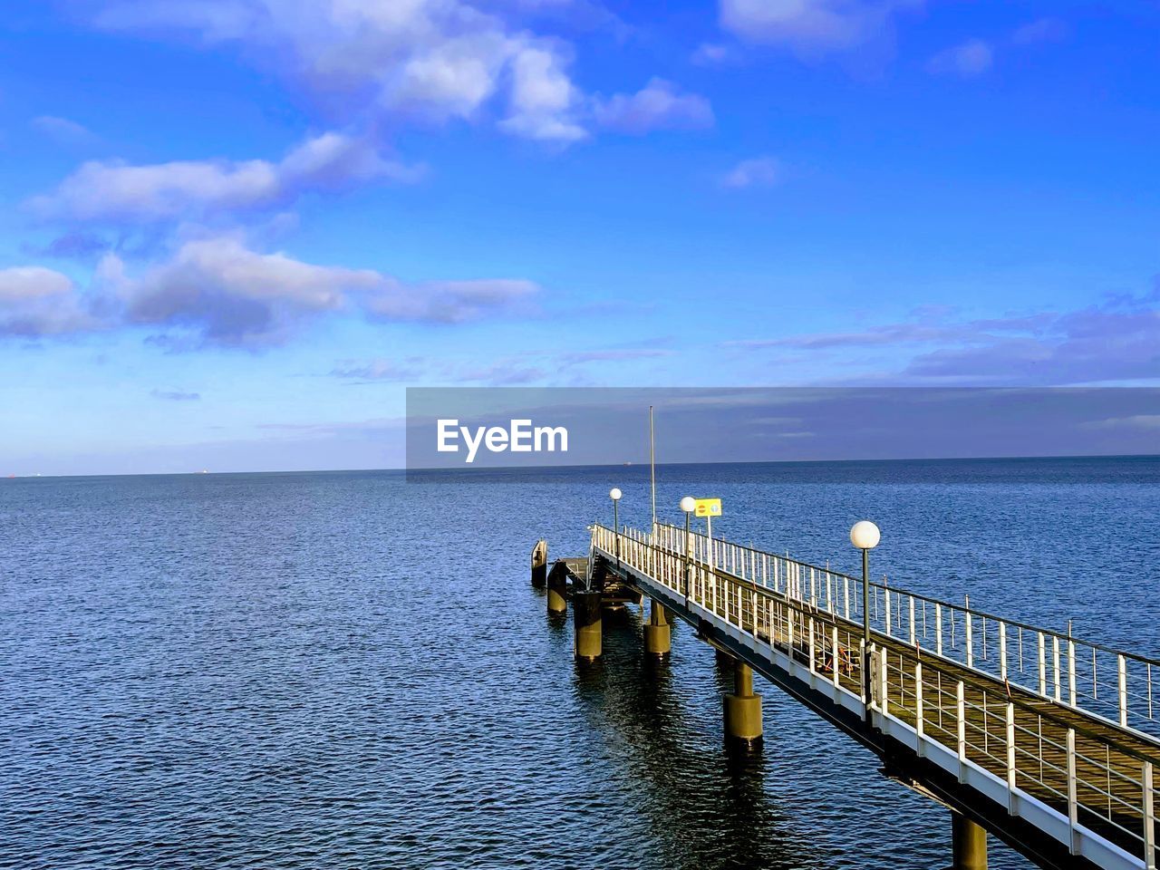 water, sea, sky, horizon, cloud, ocean, horizon over water, scenics - nature, shore, beauty in nature, nature, pier, transportation, blue, coast, tranquility, architecture, travel, tranquil scene, bay, land, travel destinations, beach, built structure, nautical vessel, holiday, seascape, idyllic, outdoors, no people, vacation, channel, trip, vehicle, dusk, tourism, day, urban skyline, railing, jetty, environment, mode of transportation, landscape