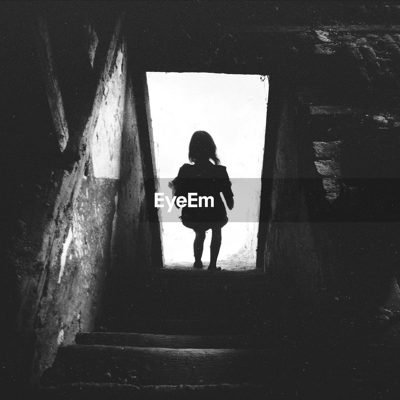 Full length rear view of girl walking down steps