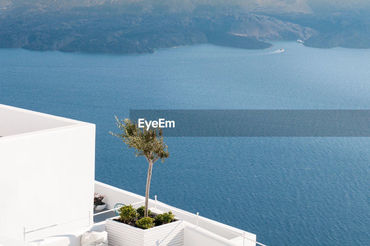 White architectural details and view of the aegean sea at oia in santorini, greece.