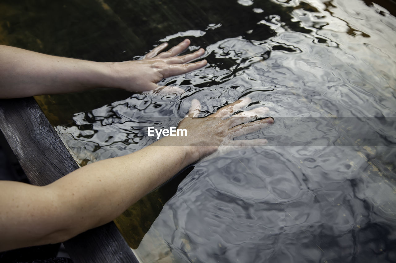 Cropped image of hands in water